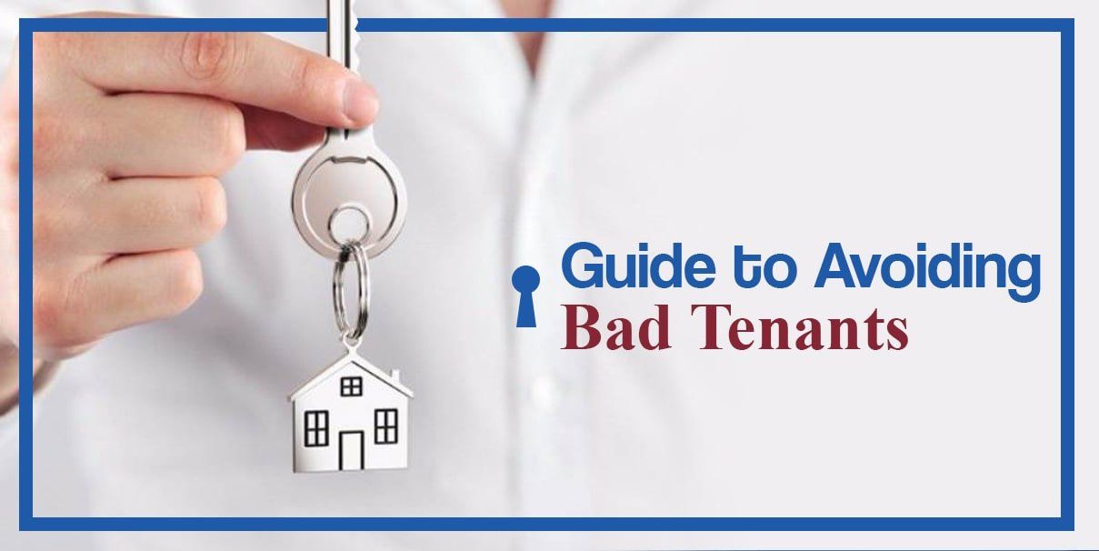 Hand holding a key with a house-shaped key chain dangling down