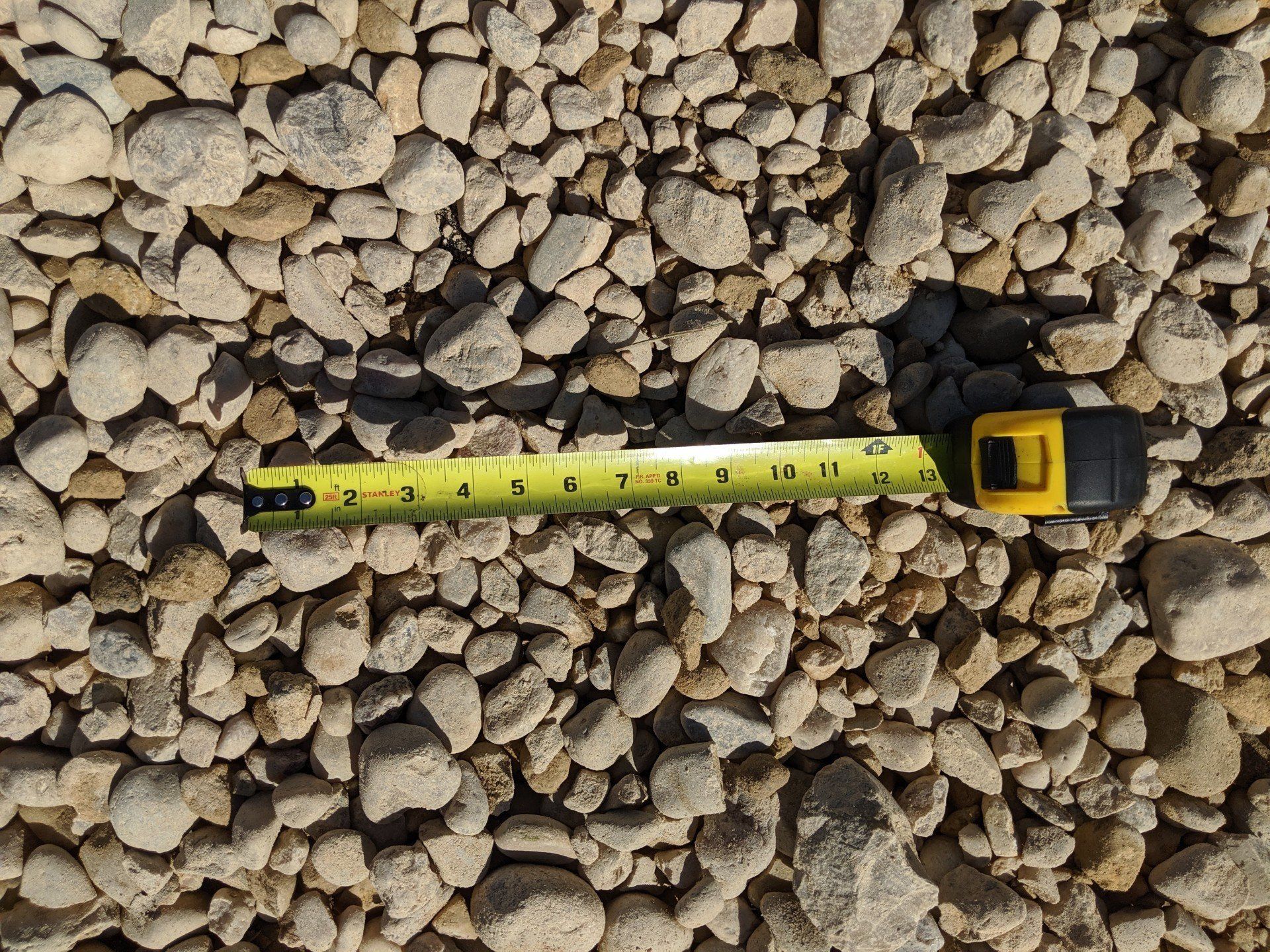 Number 3 rock with a tape measure showing they are at less than 2 inches wide.