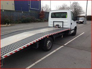 white car recovery truck