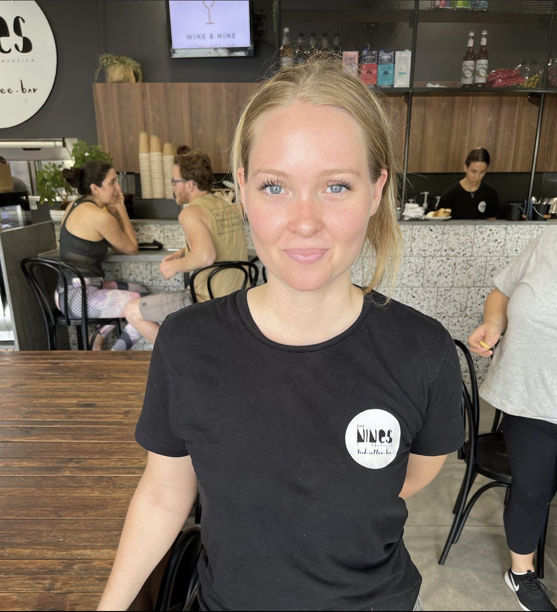 A woman wearing a black shirt that says naps on it