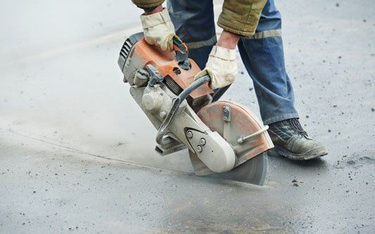 Construction Worker with Cut-off Machine - Asphalt in Medina, MN Construction Worker with Cut-off Machine - Asphalt in Medina, MN