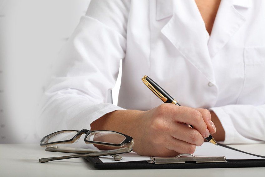 Psychiatrists writing with a black and gold pen