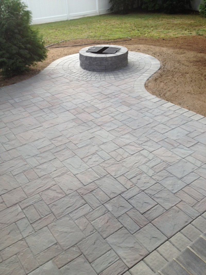 round grey stone fire place with a grey stone rings around fire place