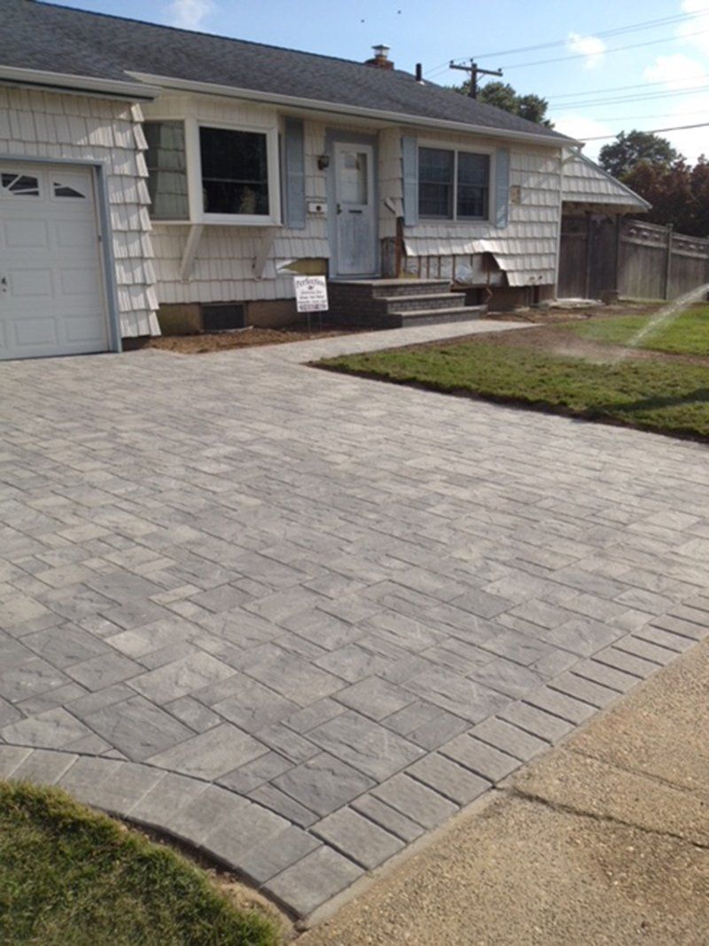 front of a house showing driveway made with  grey stones