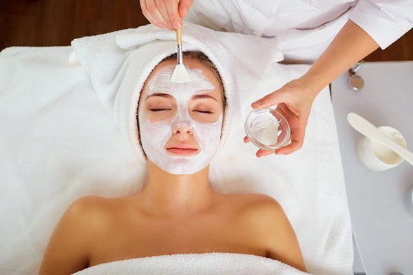 Beauty Salon — Woman In Mask On Face In Spa Beauty Salon in Temple Hills, MD Beauty Salon — Woman In Mask On Face In Spa Beauty Salon in Temple Hills, MD