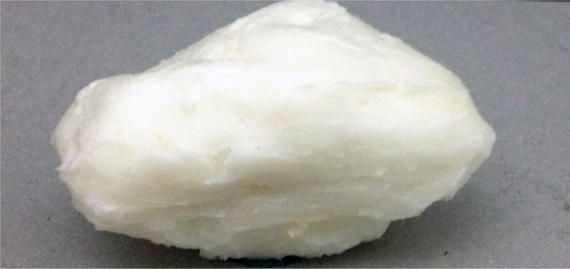 A white ball is sitting on a gray surface