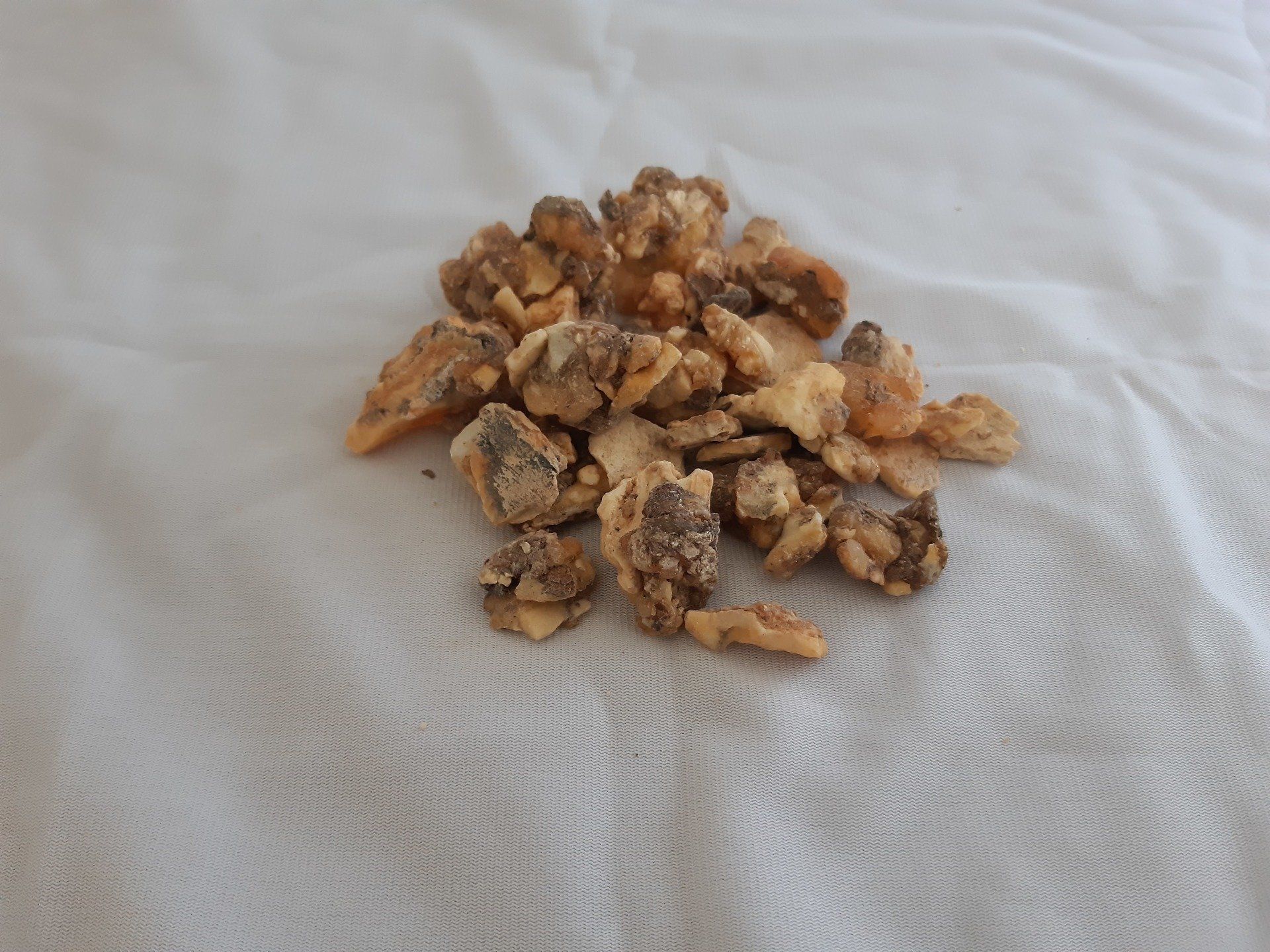 A pile of nuts is sitting on a white cloth