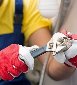 a close up of a person holding a wrench in their hands .