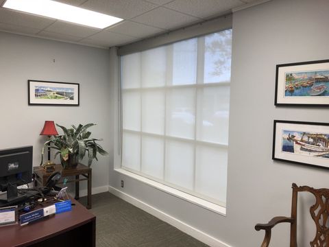 Wood Plantation Shutters — Room with Solar Shade on the Window in Baton Rouge, LA