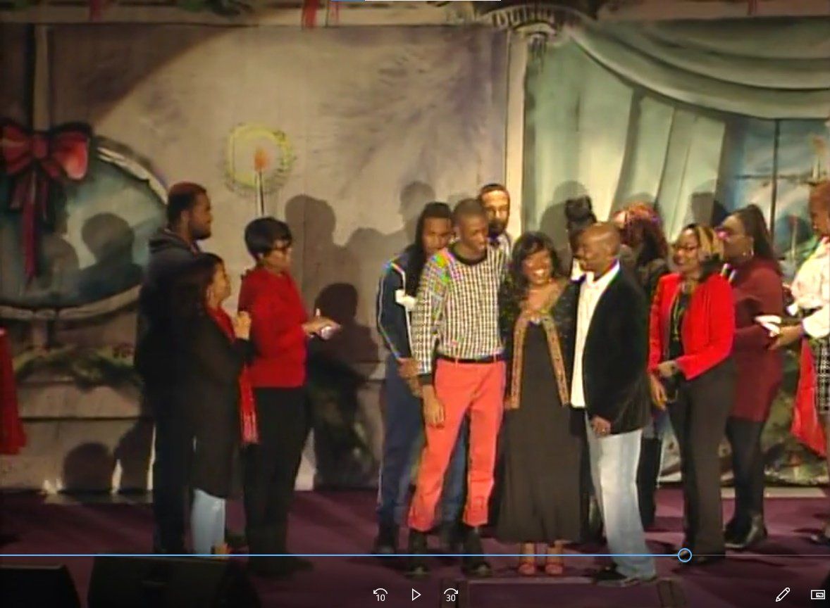 A group of people are posing for a picture on a stage.