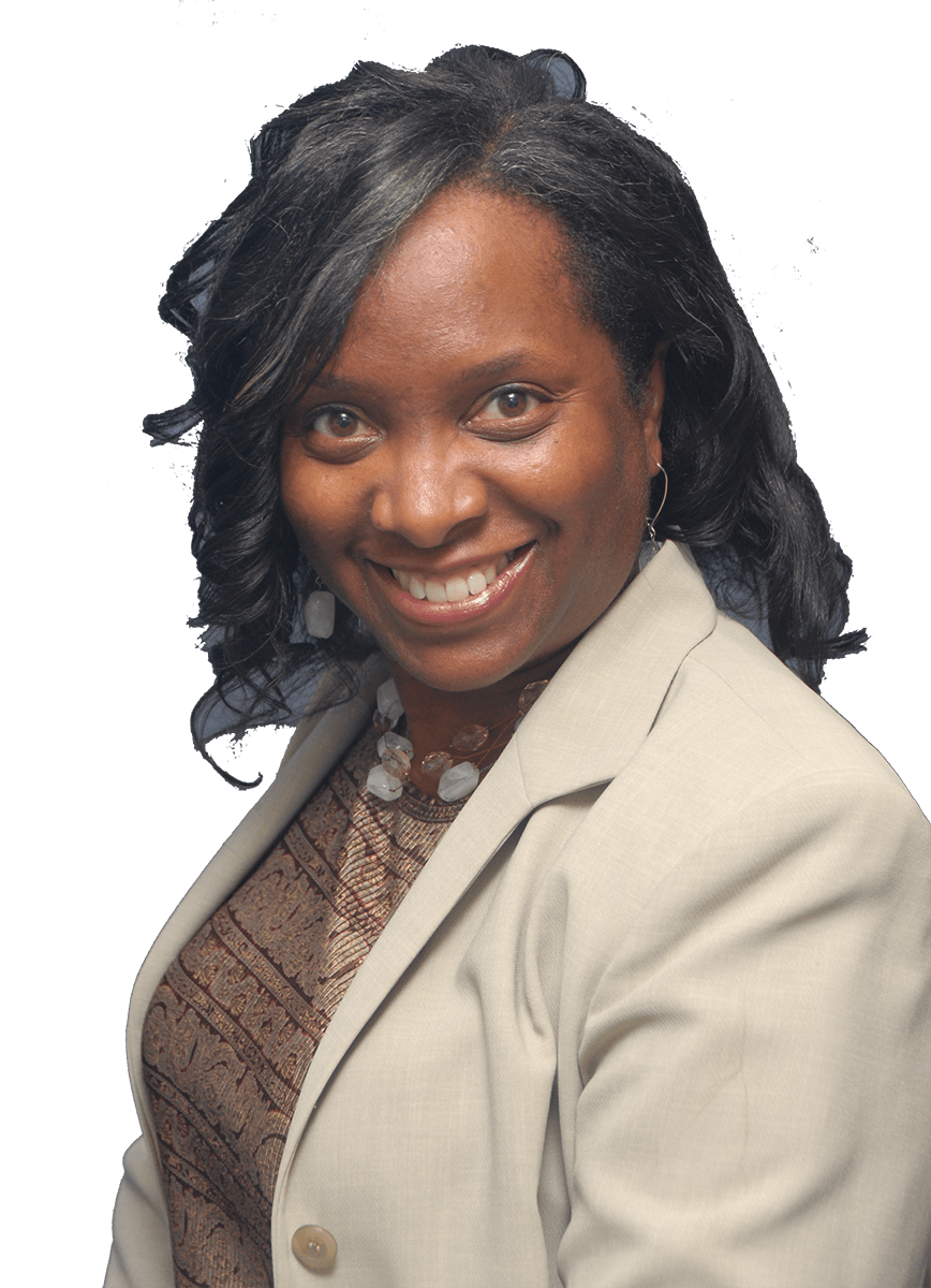A woman in a tan jacket is smiling for the camera