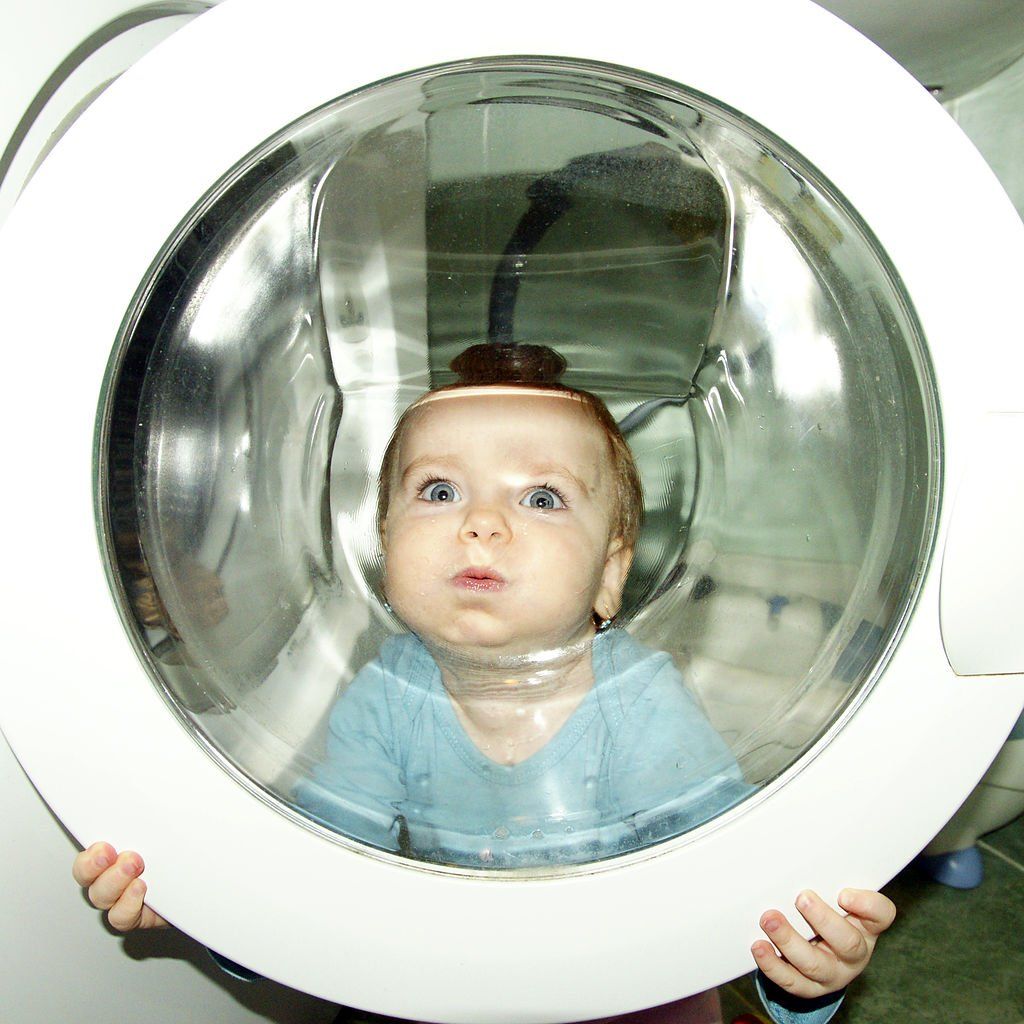 Baby awwww! Baby looking through a washing machine door glass