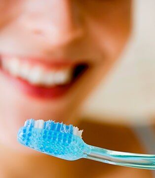 Woman Flossing Her Teeth — Dental Services in Deerfield Beach, FL Woman Flossing Her Teeth — Dental Services in Deerfield Beach, FL