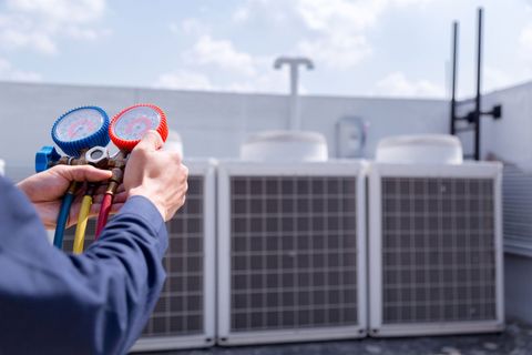 Technician Is Checking Air Conditioner — Circleville, OH — Schooley’s Heating & Cooling Technician Is Checking Air Conditioner — Circleville, OH — Schooley’s Heating & Cooling