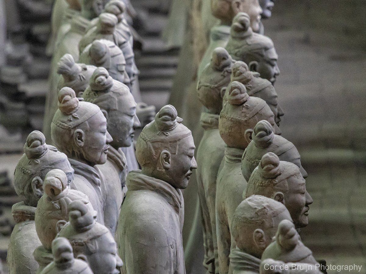 Terracotta Army soldiers in formation, faces with subtle expressions, various hairstyles, earthy tones.