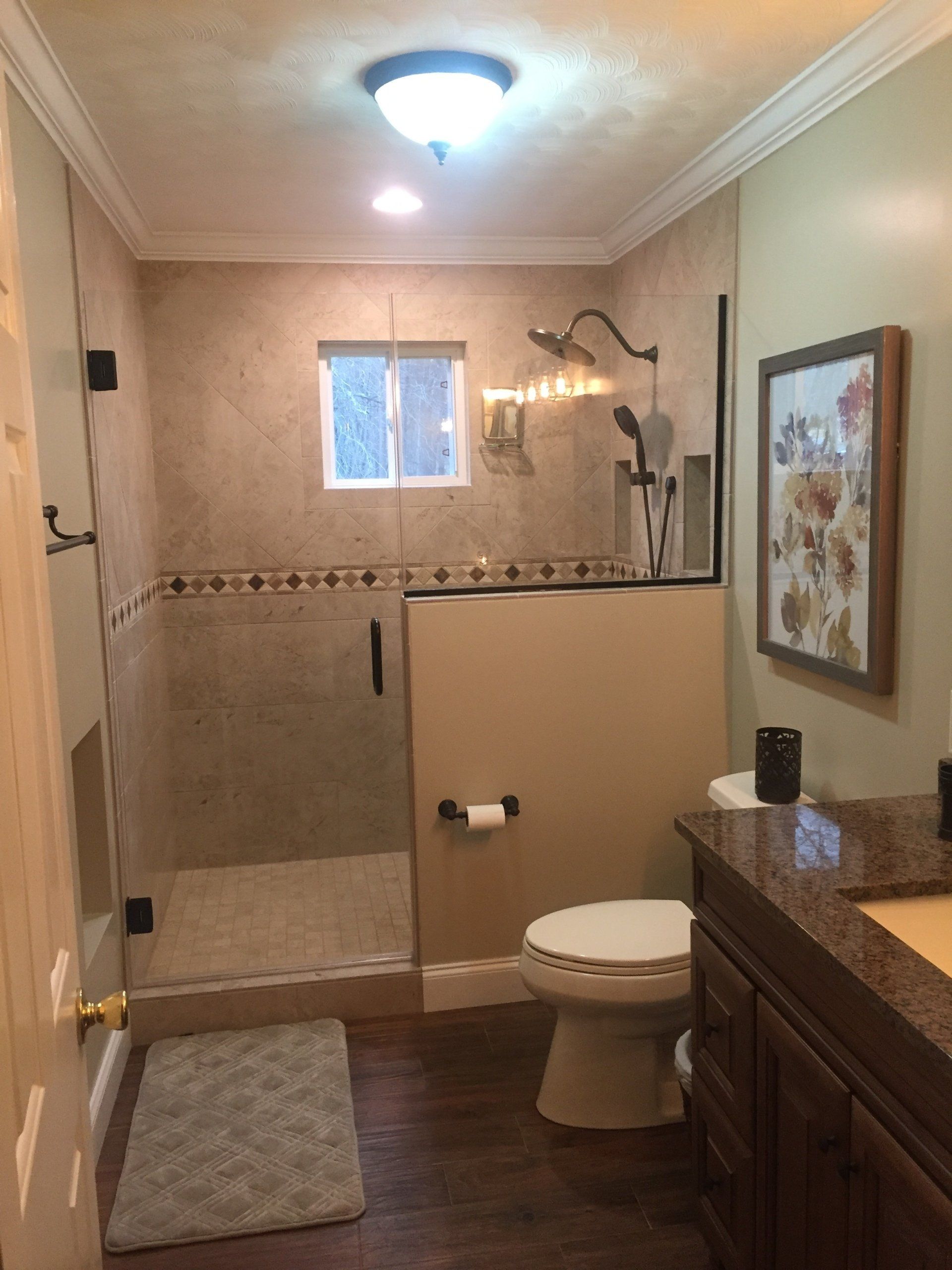 Custom glass shower with clear panels and sleek hardware by Rhodes Glass NC.