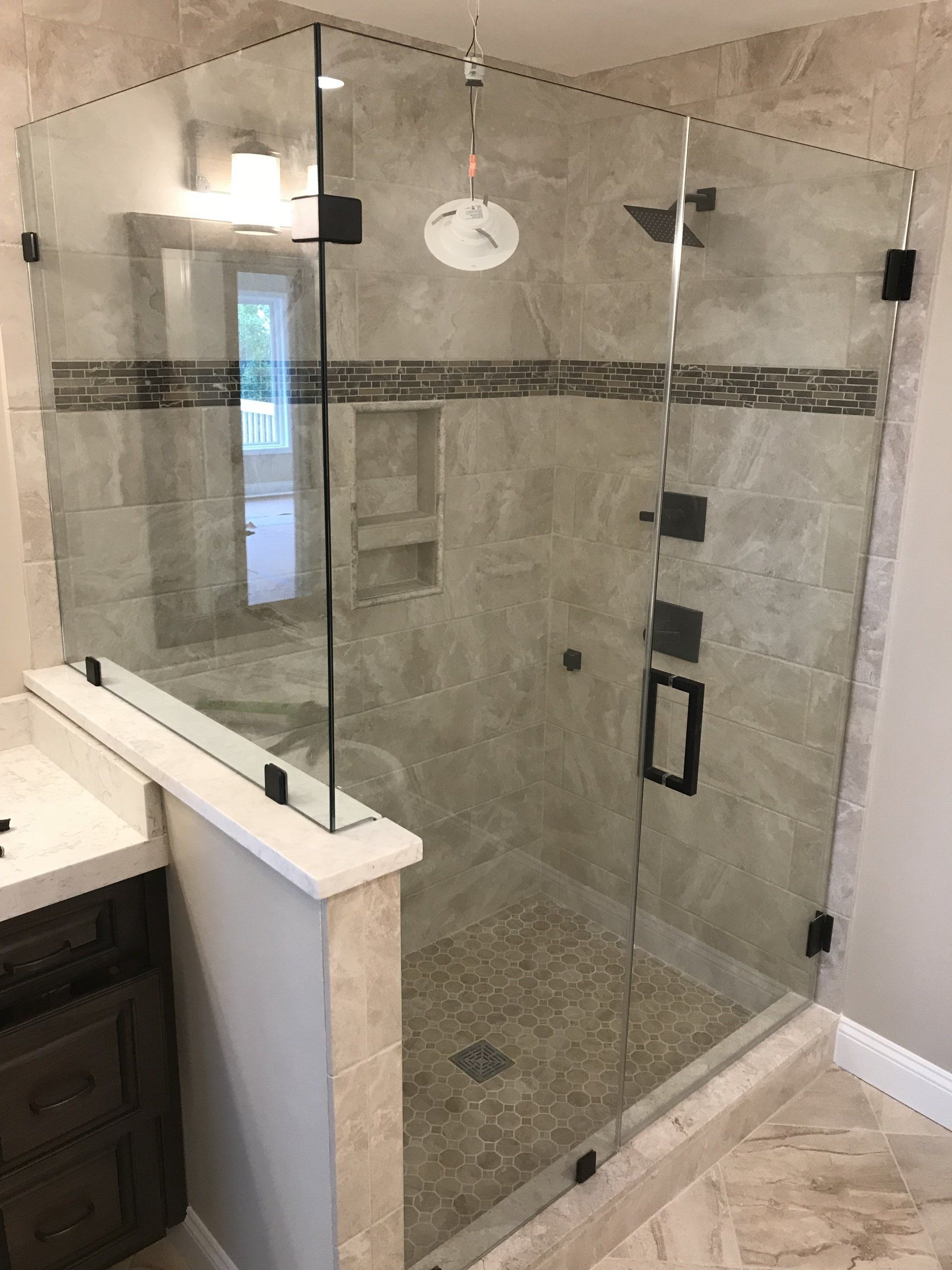 Custom glass shower with sleek hardware by Rhodes Glass Asheville, NC.