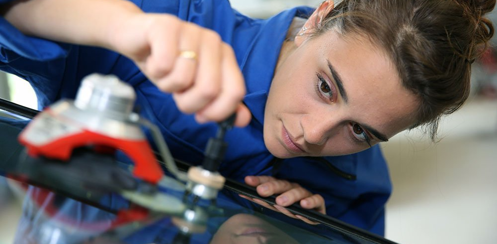 Woman Fixing Chipped Windshield Woman Fixing Chipped Windshield
