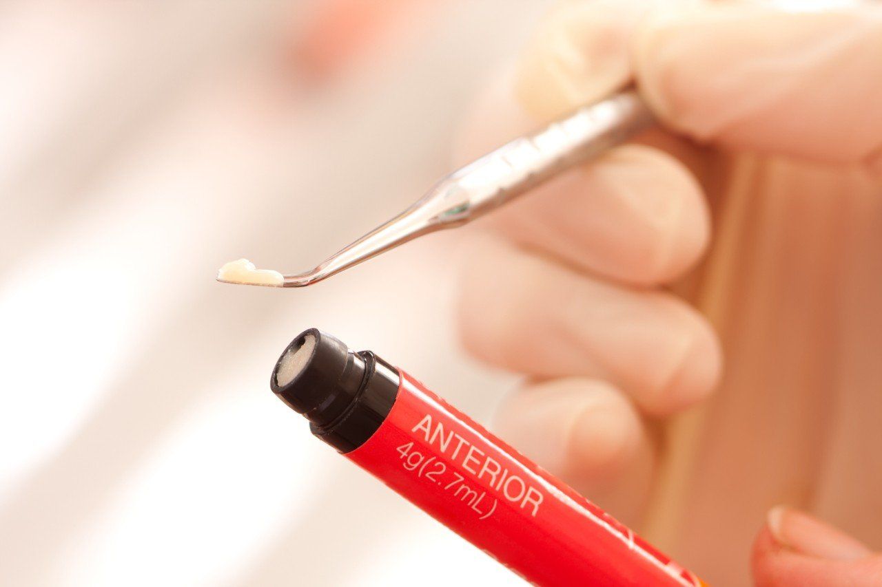 A person is holding a red tube that says anterior on it.