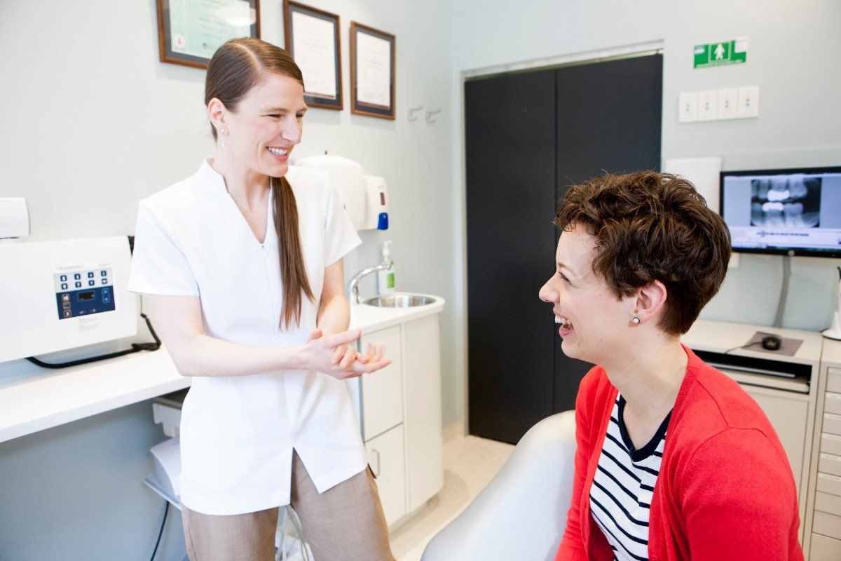 dental hygienist with patient