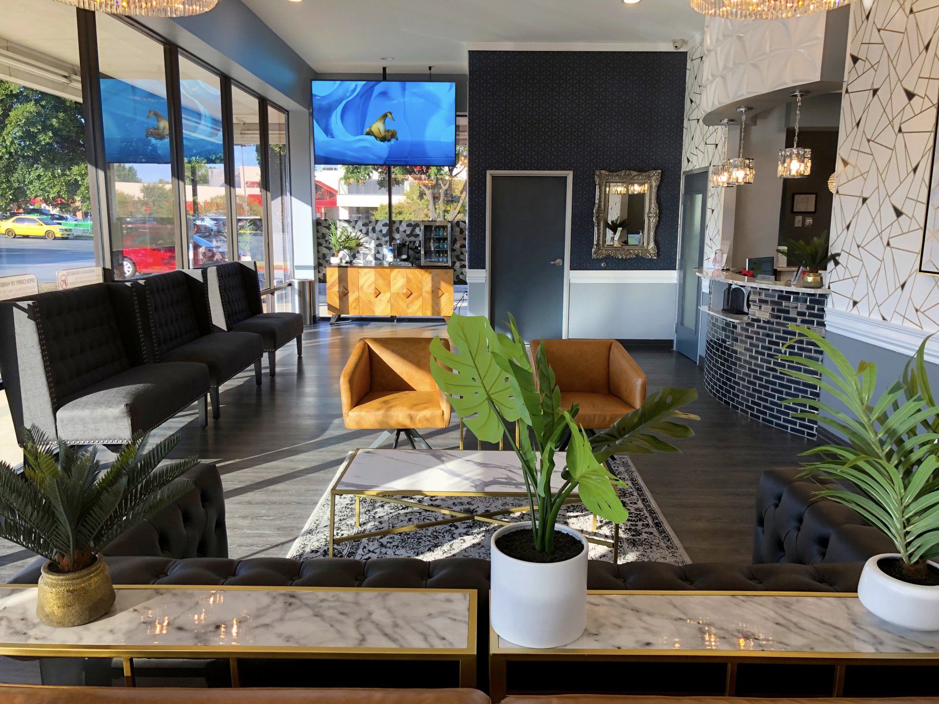 Lucent Dentistry in Austin Tx. A living room filled with furniture and plants in a hotel lobby.