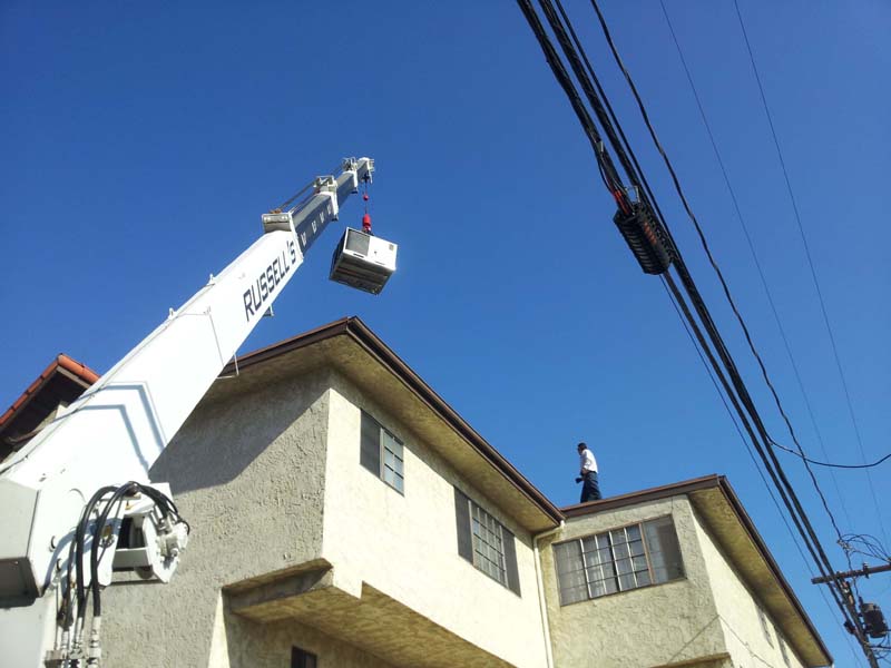 new_package_unit_lifted_by_crane_installation
