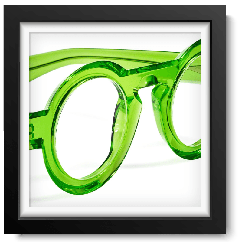 Black picture frame with close-up picture of a lime green translucent glasses