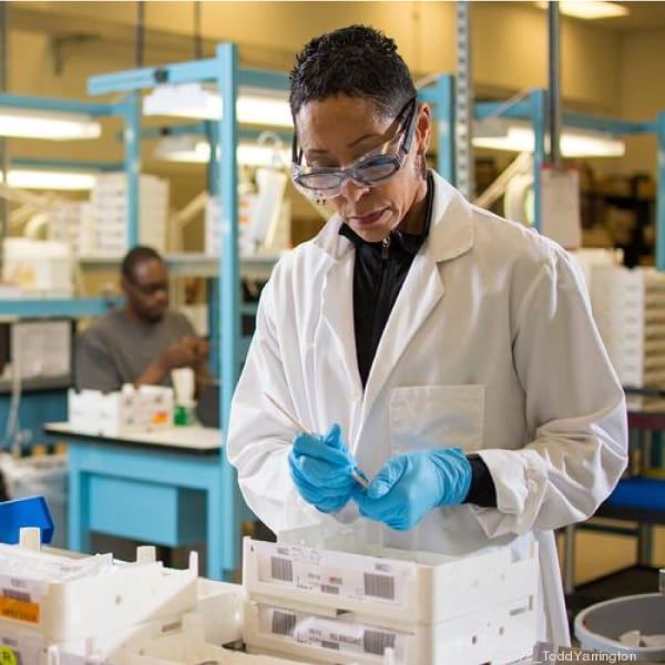 Woman manufacturing custom lenses in a lab