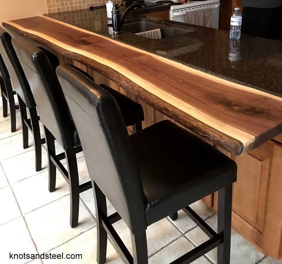Eat in kitchen live edge wood bar top. Kitchen bar top made with live edge Walnut, attached to counter top.
