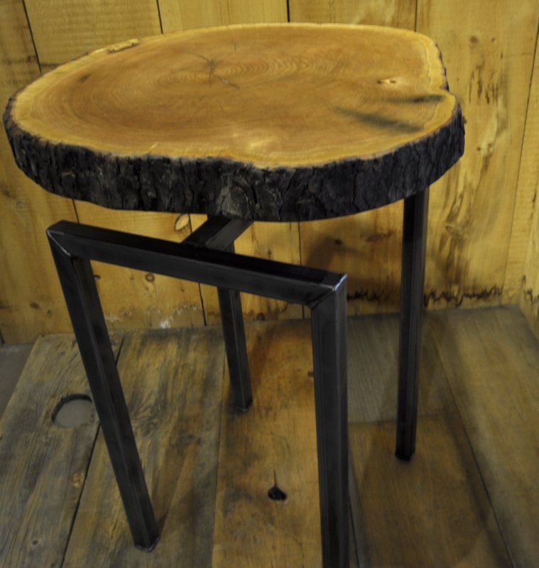Live edge wood slice table with steel lags.