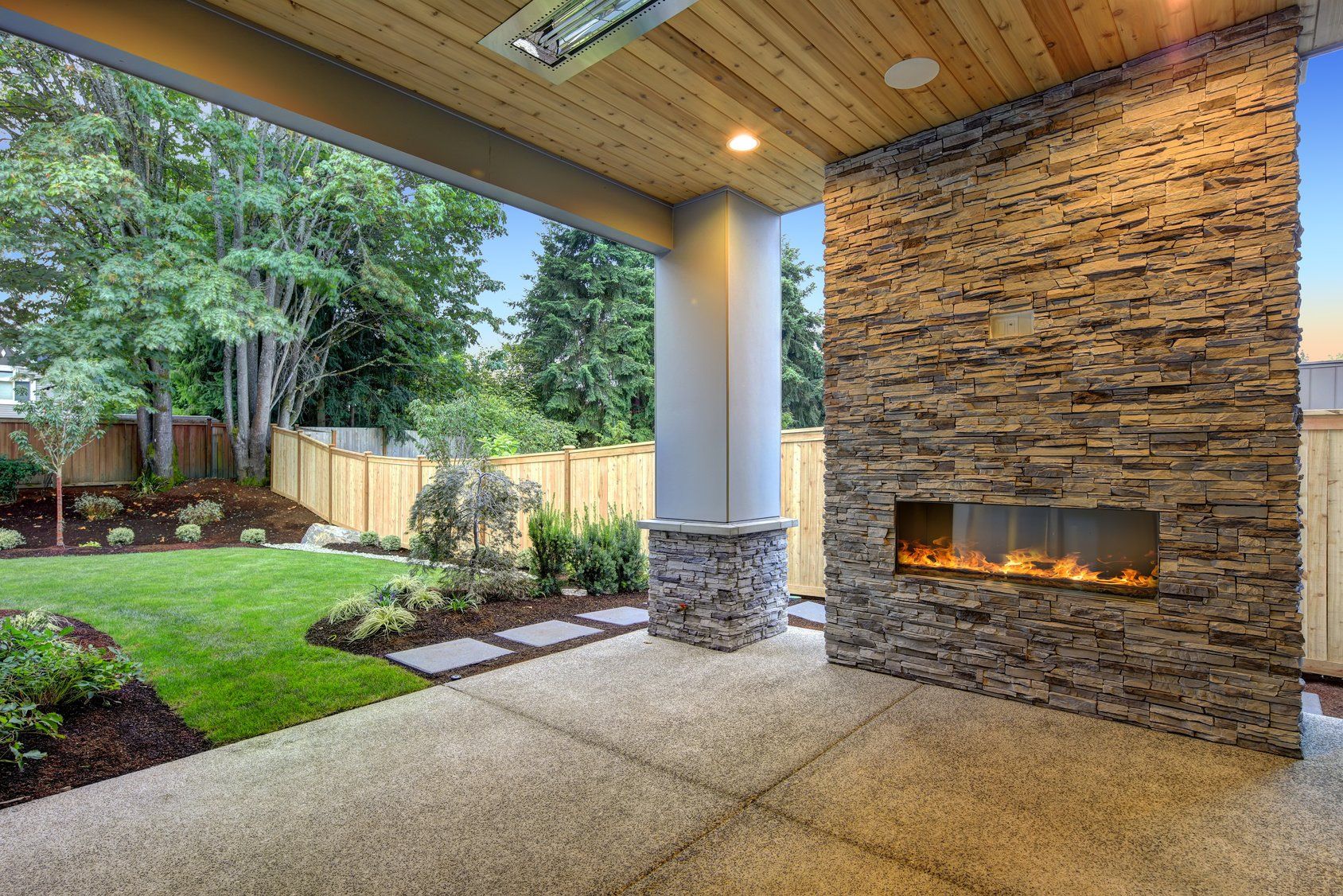 There is a fireplace in the middle of the patio.