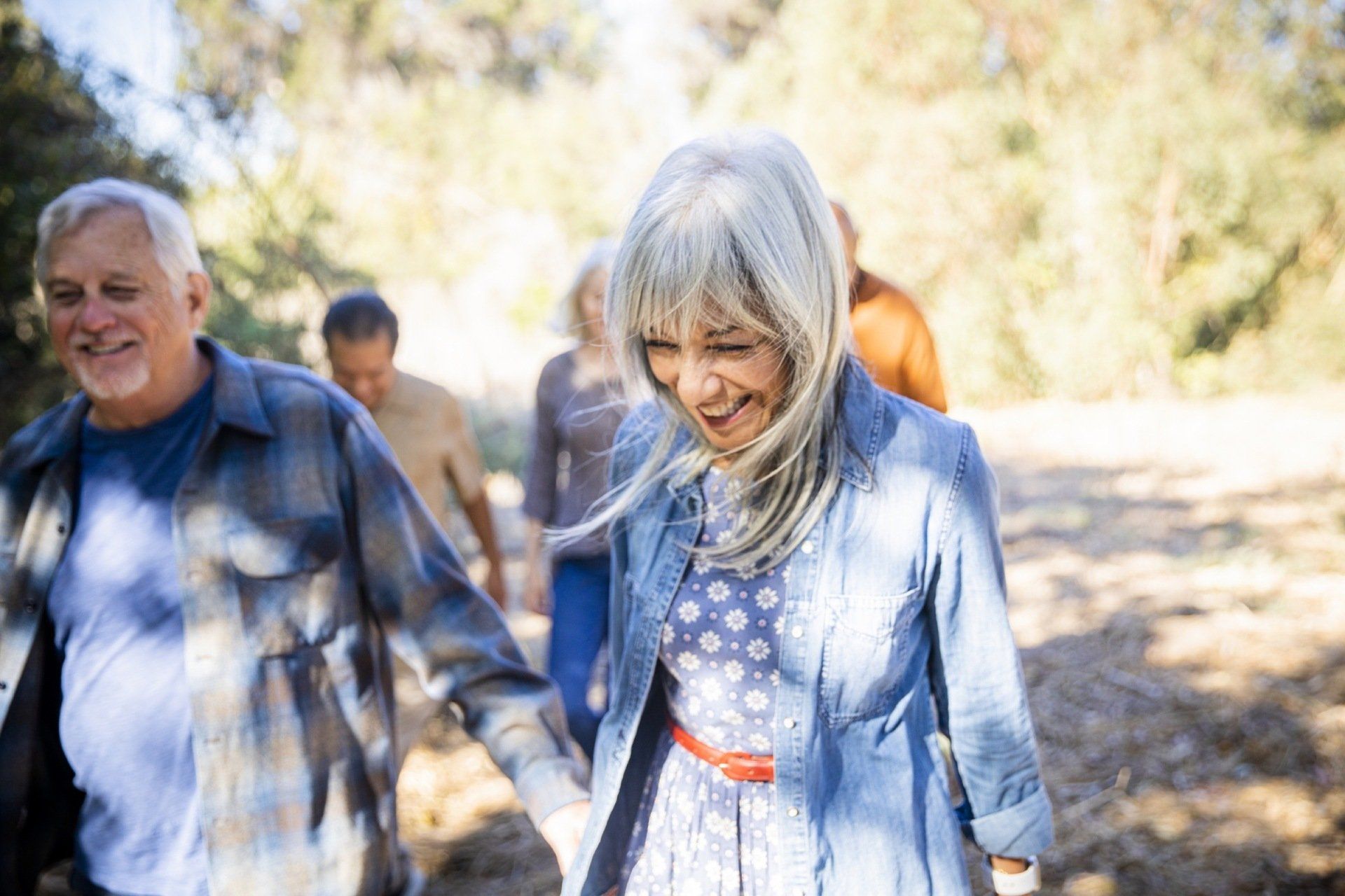 senior woman walking with a smile outside
