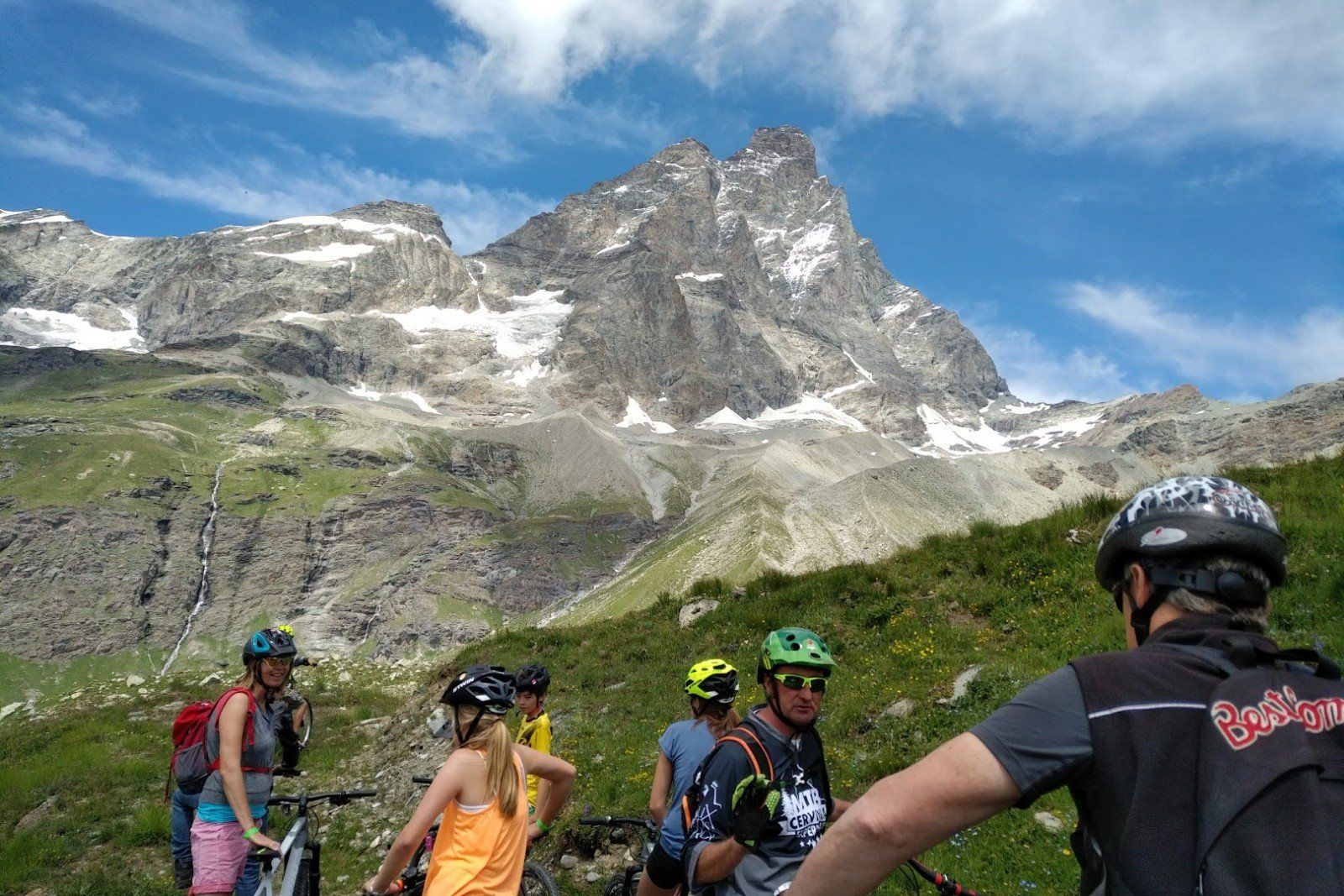Cervinia in summer. Picture of people mountain biking with Matterhorn in the back