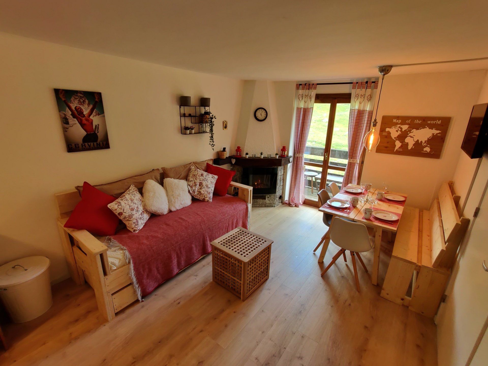 Photo of the whole living room with sofa bed and set table