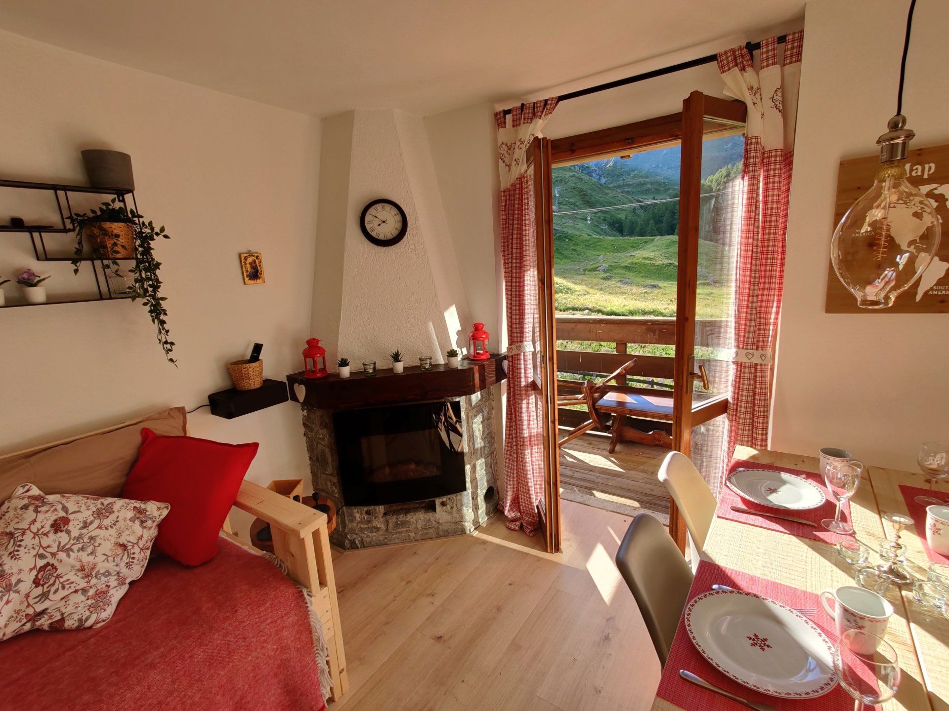 A living room with set table, fireplace, sofa bed and Mountain View 