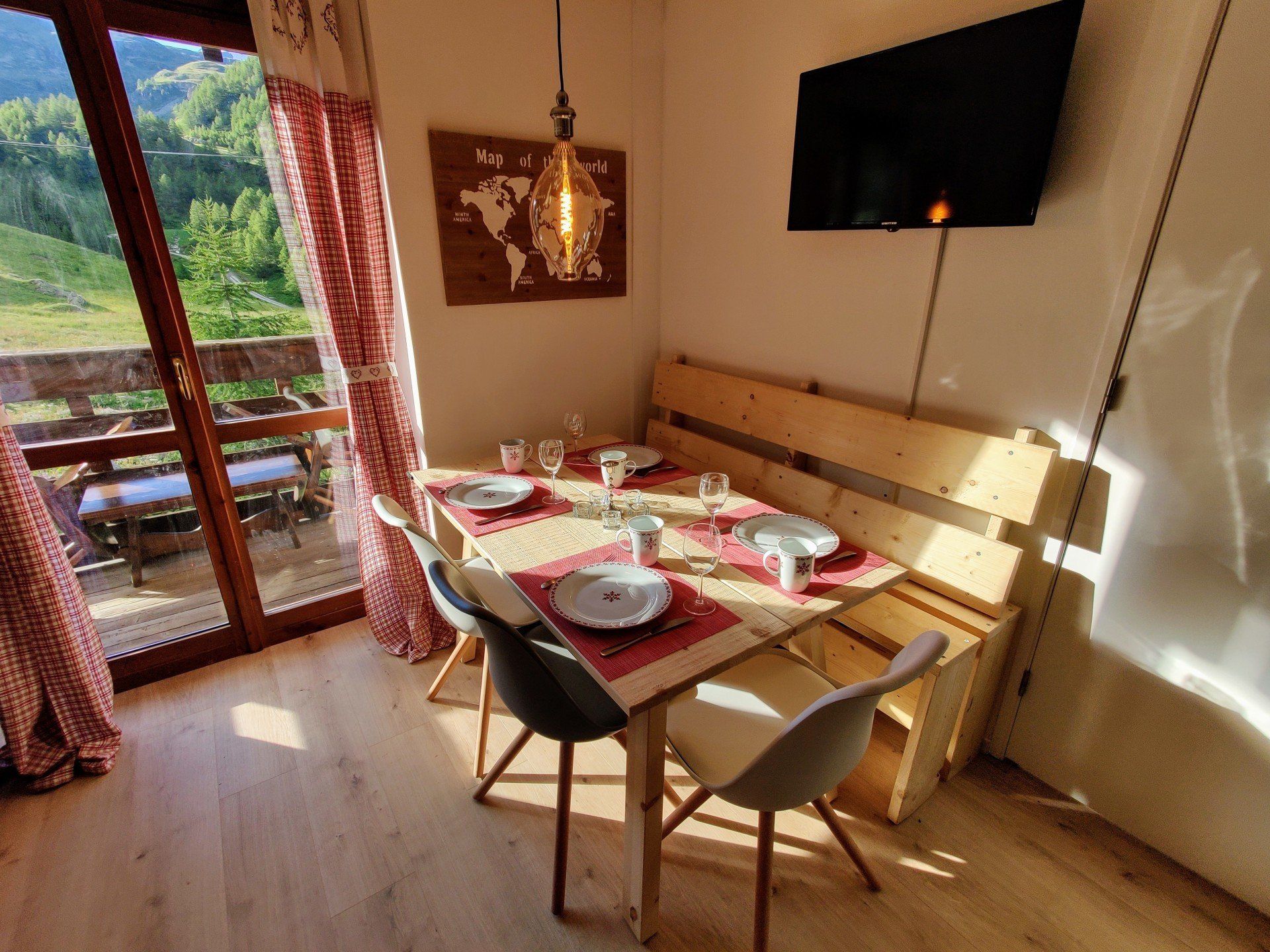 Living room with a set table, tv and Mountain View.