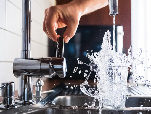 Faucet filling up glass, water testing, Wild Blue Home Inspections Water Testing