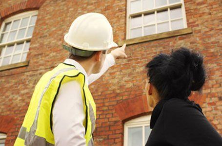 specialists surveying the wooden window