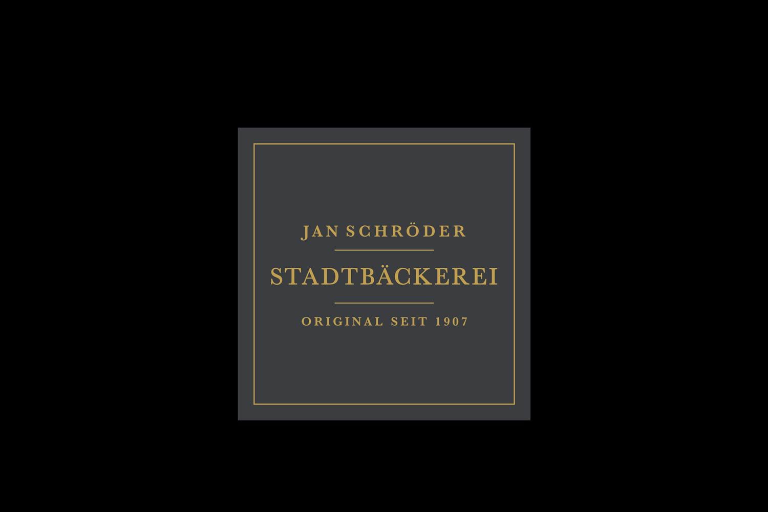 A black and gold logo for jan schroder stadtbackerei