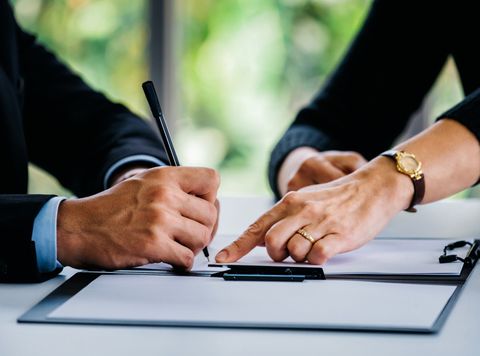 Attorney Pointing On Paper And Man Signing — Oklahoma City, OK — Murphy & Murphy Attorneys