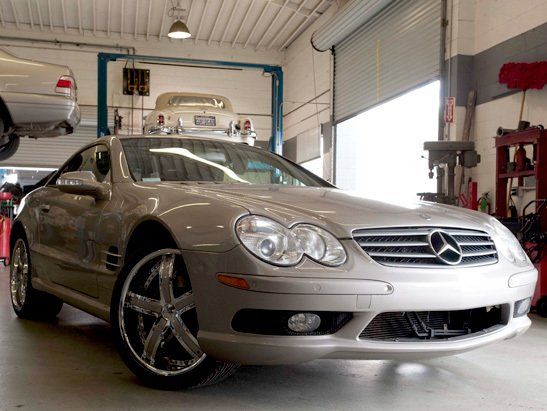 Jag Repair — Car on Lift at Auto Mechanic Shop in Modesto, CA Jag Repair — Car on Lift at Auto Mechanic Shop in Modesto, CA