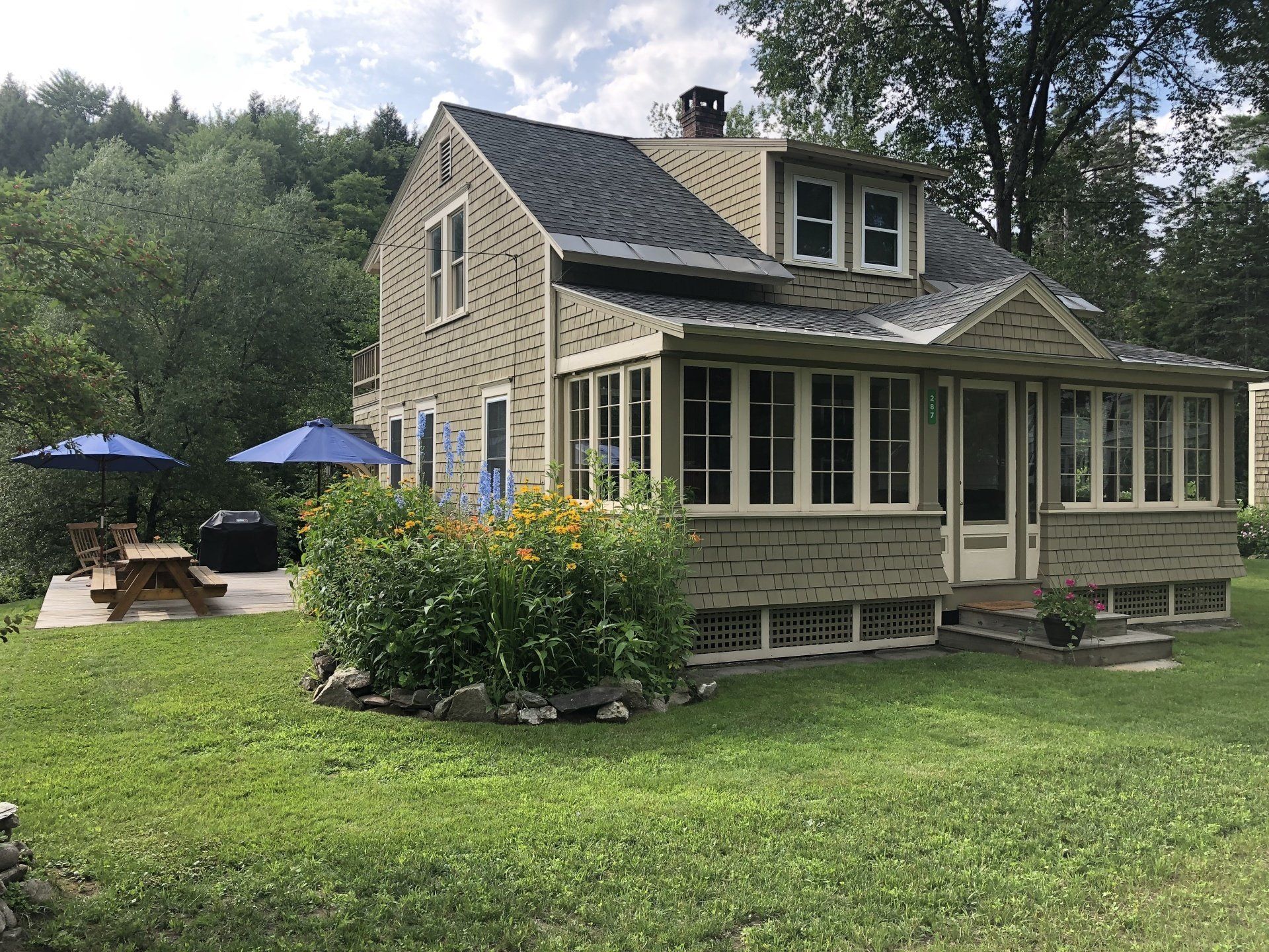The Riverside Cottage riverbank view in East Burke, VT