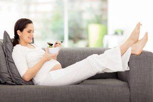 Pregnant Woman Relaxing While Eating — A Child's Dream Pregnant Woman Relaxing While Eating — A Child's Dream