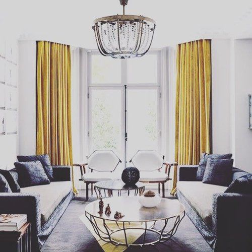 A large white room with yellow curtains