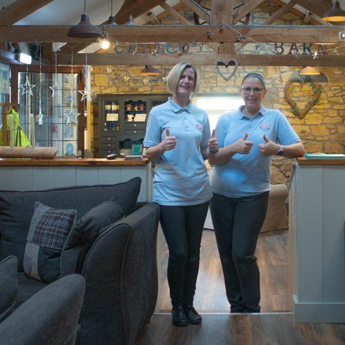 Two cleaners giving a thumbs up