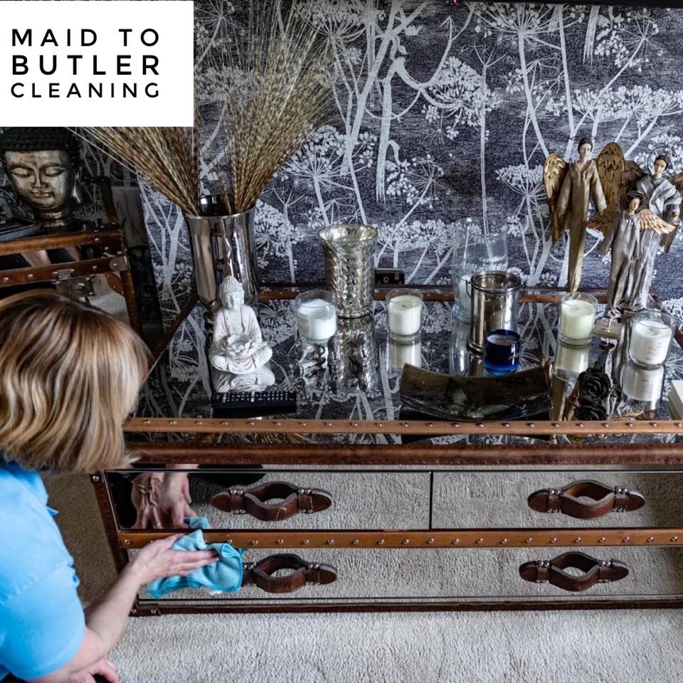 Maid to Butler cleaner wiping down furniture