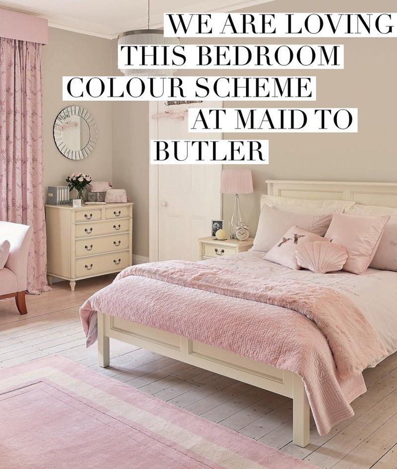 A large pink and white bed in a pink and white bedroom