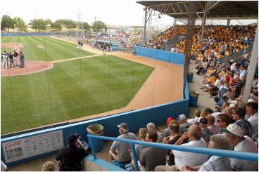 A crowd of people are watching a baseball game in a stadium