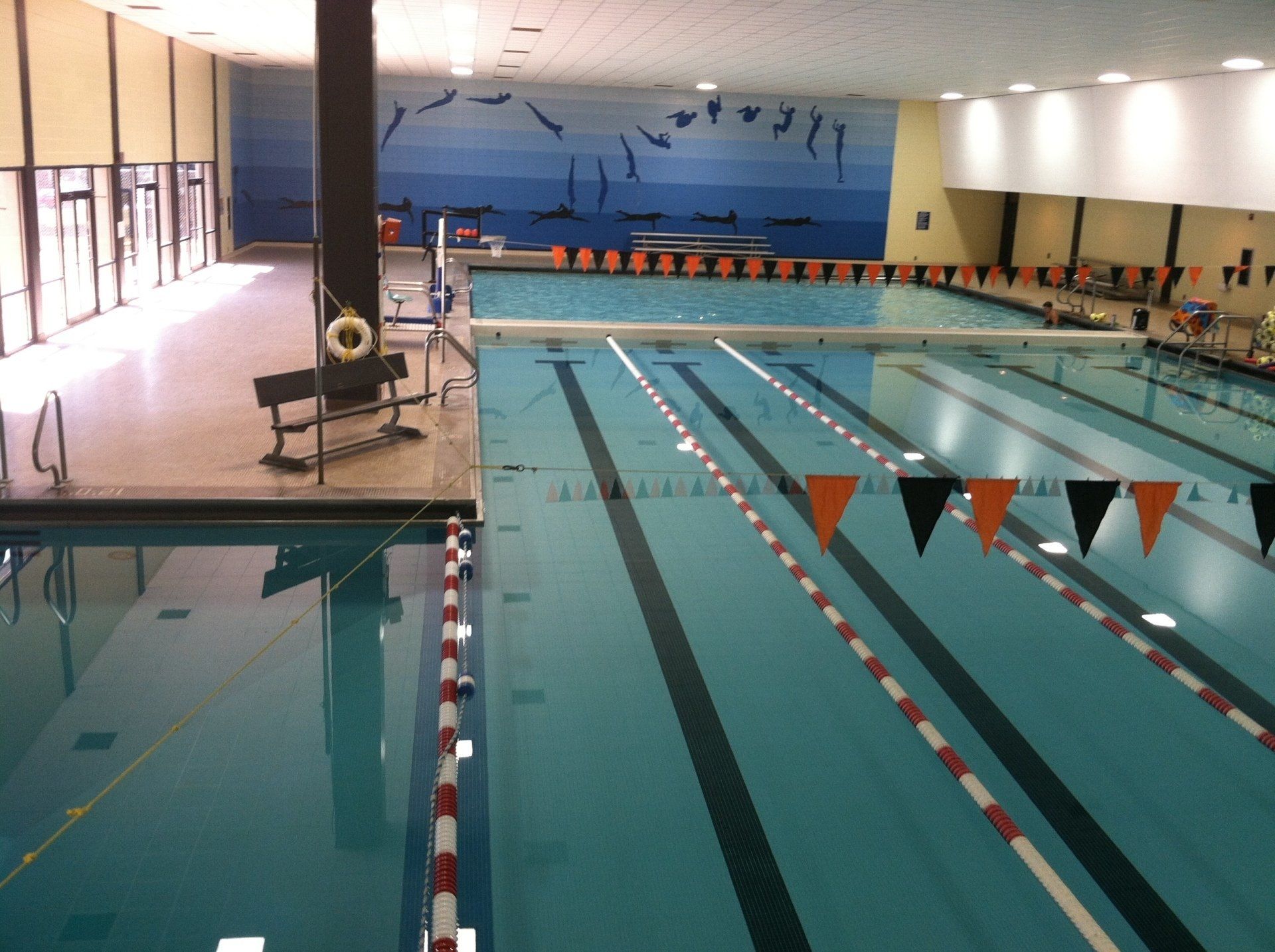 A large indoor swimming pool with a life preserver on the side