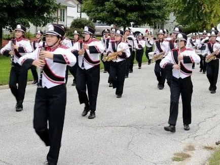 A marching band is marching down a street